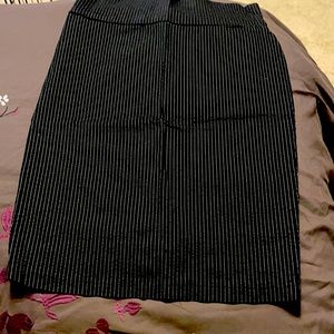 Black pencil skirt with white pin stripes.